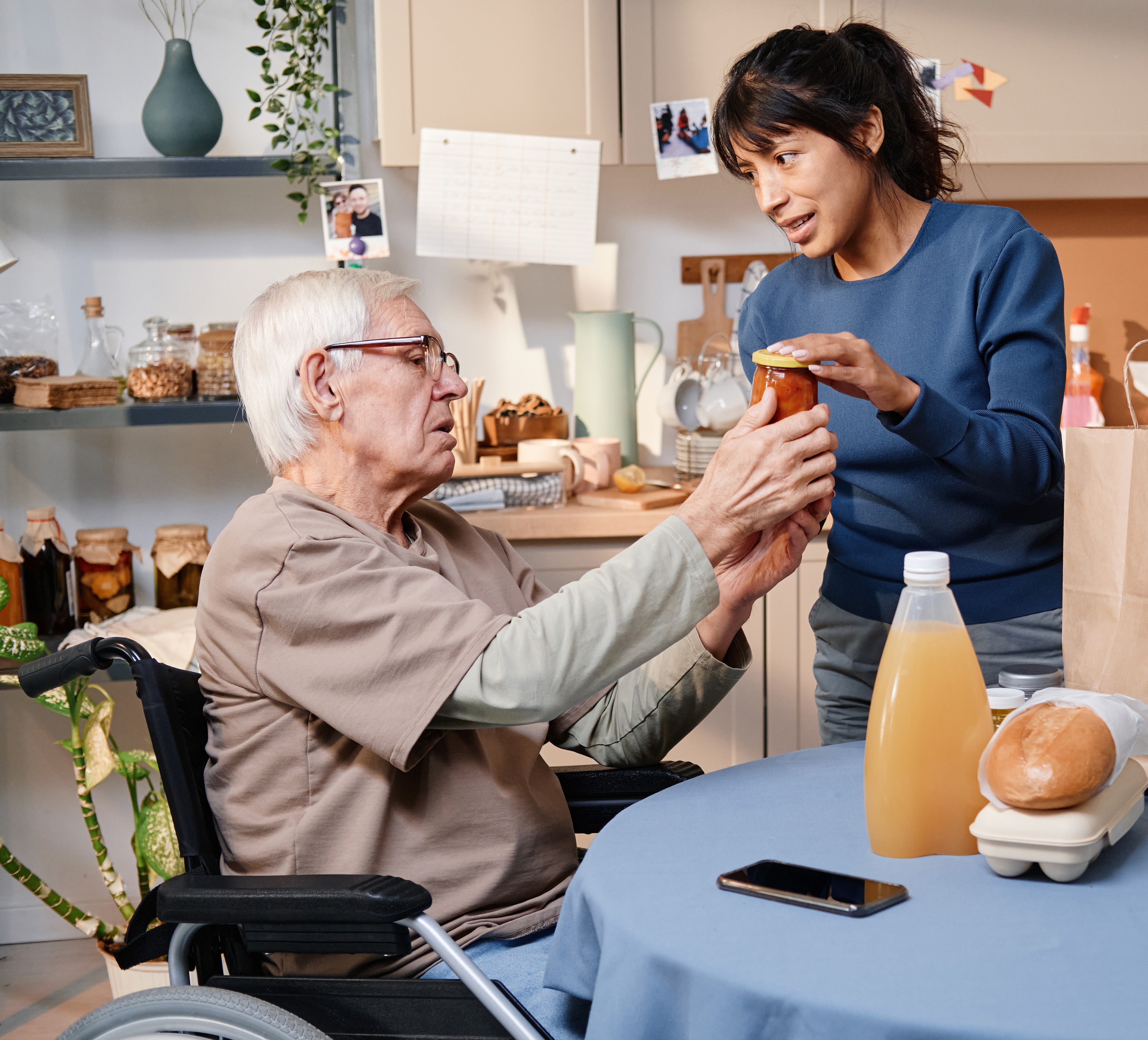 Caregiver assisting an elderly person with stairs